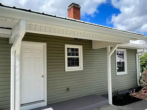 New white gutters installed on small home